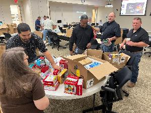 The offshore team coming together to organize the toys for the kits.